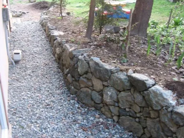 A retaining wall built to transition grade away from a house
