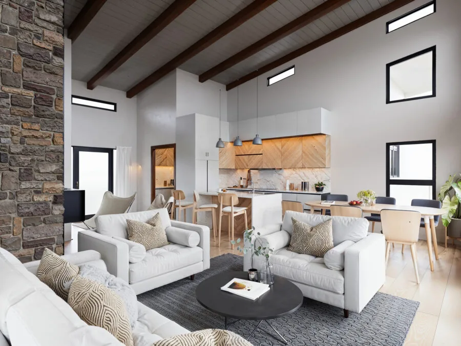 Modern open-concept living space with white seating, wooden kitchen, exposed beams, and stone fireplace. (3 of 4)