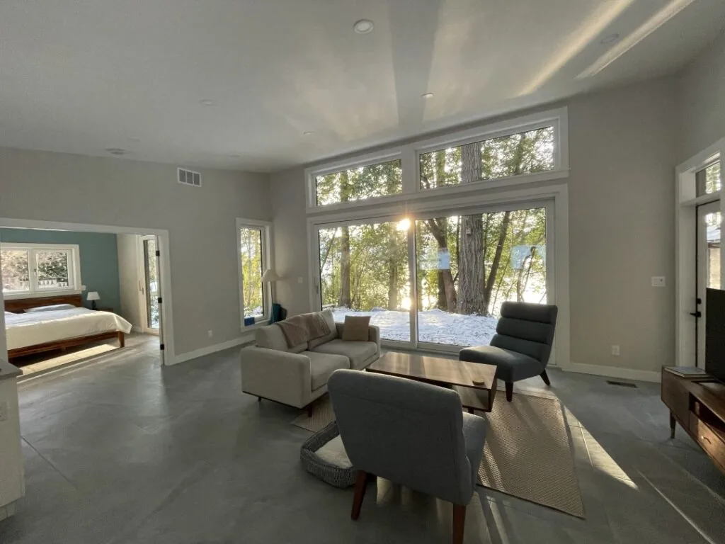 The open living space of the ADU, showcasing its sprawling triple-pane windows