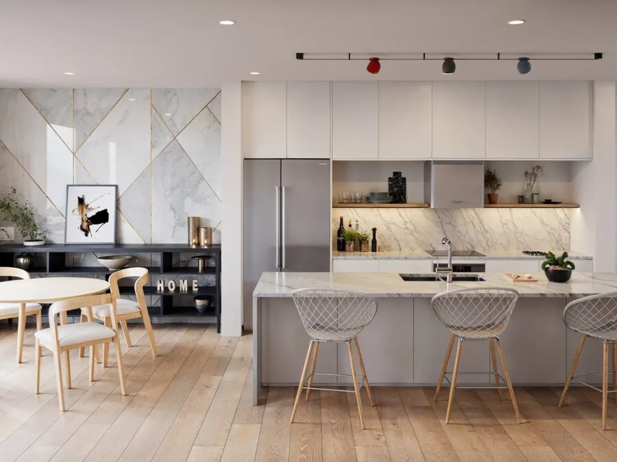 Modern open-plan kitchen and dining area with marble backsplash, gray cabinetry, island seating, and wooden furniture. (2 of 4)